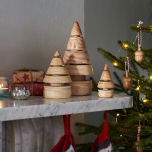 handmade wooden christmas tree set on a mantlepiece