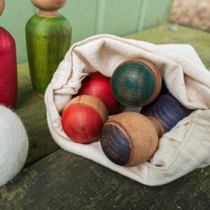 Wooden skittles in a cotton drawstring bag.