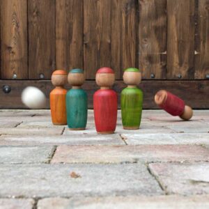 White felt ball knocking down a colourful wooden skittle.
