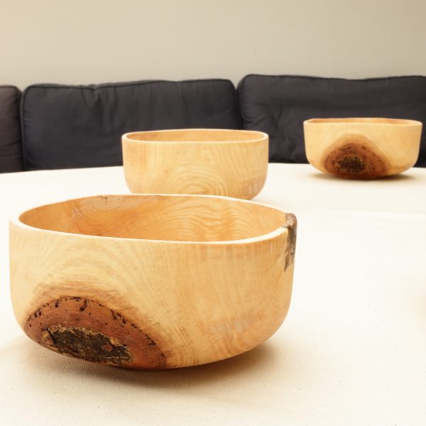 wooden bowls with bark on on a table