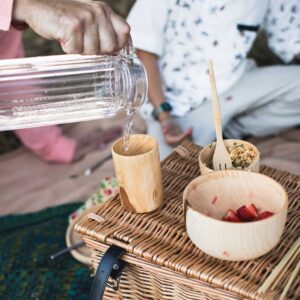 pouring water into a wooden cup
