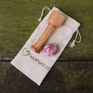 wooden cup and ball game with pink ball.