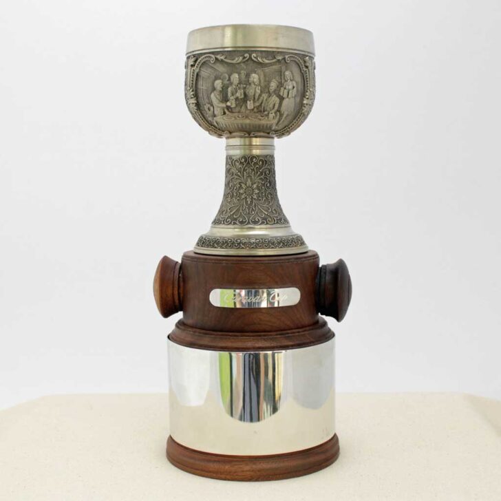 A golf trophy with a wooden base displayed on a white surface