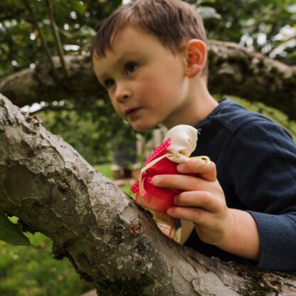 boy playing with a love heartwood crafty peg doll