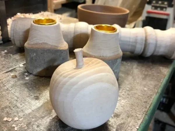 A wooden apple and a pair of natural edge candlesticks