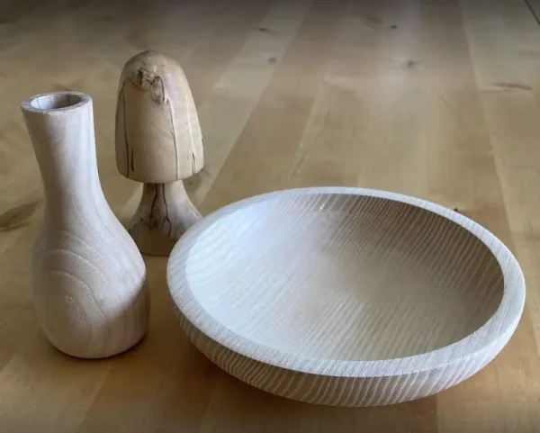 A toadstool, bowl and bud vase turned from wood.