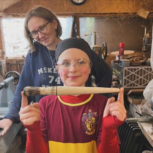 Boy holding a turned wooden magic wand