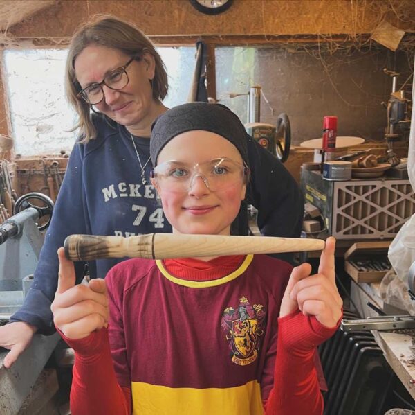 Boy holding a turned wooden magic wand