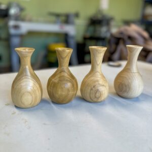 A group of students' wooden bud vases from the Mother's Day course