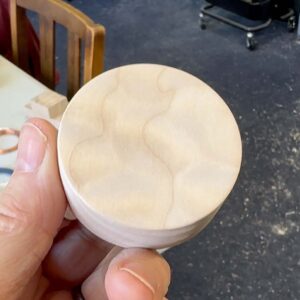 Round wooden ring box made from curly maple.