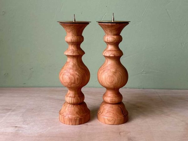 Completed pair of matching wooden candlesticks turned on a lathe.
