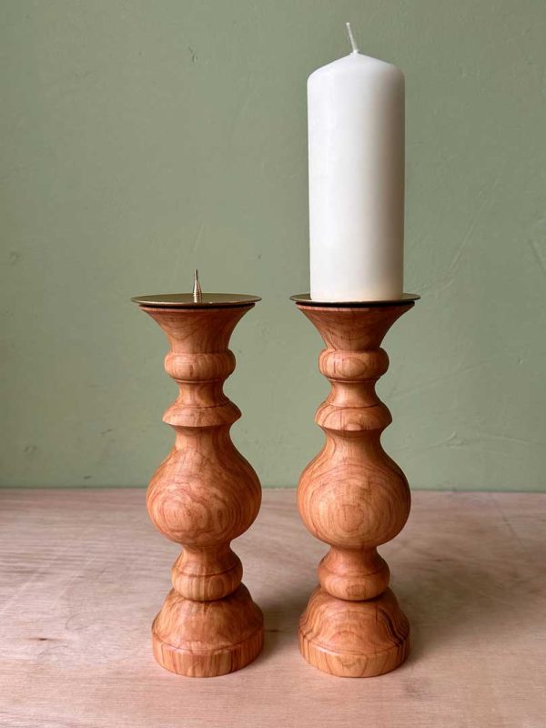 A finished pair of turned wood candlesticks for pillar candles.