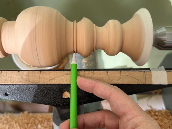 Turning matching candlesticks on a lathe.