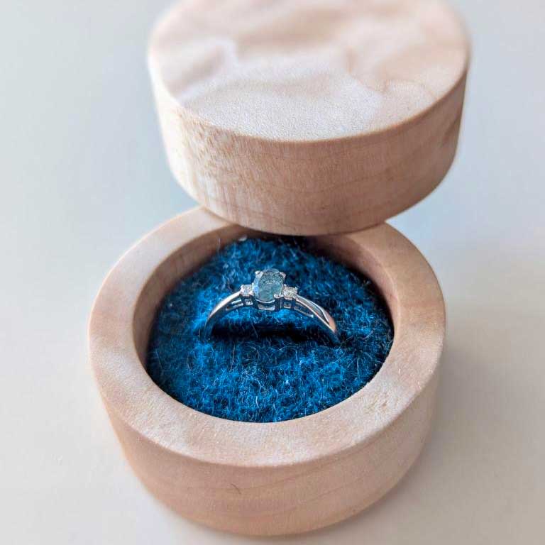 maple box with engagement ring inside