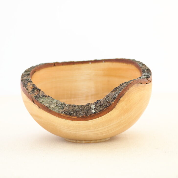 A wooden bowl featuring a decorative metal band encircling its rim