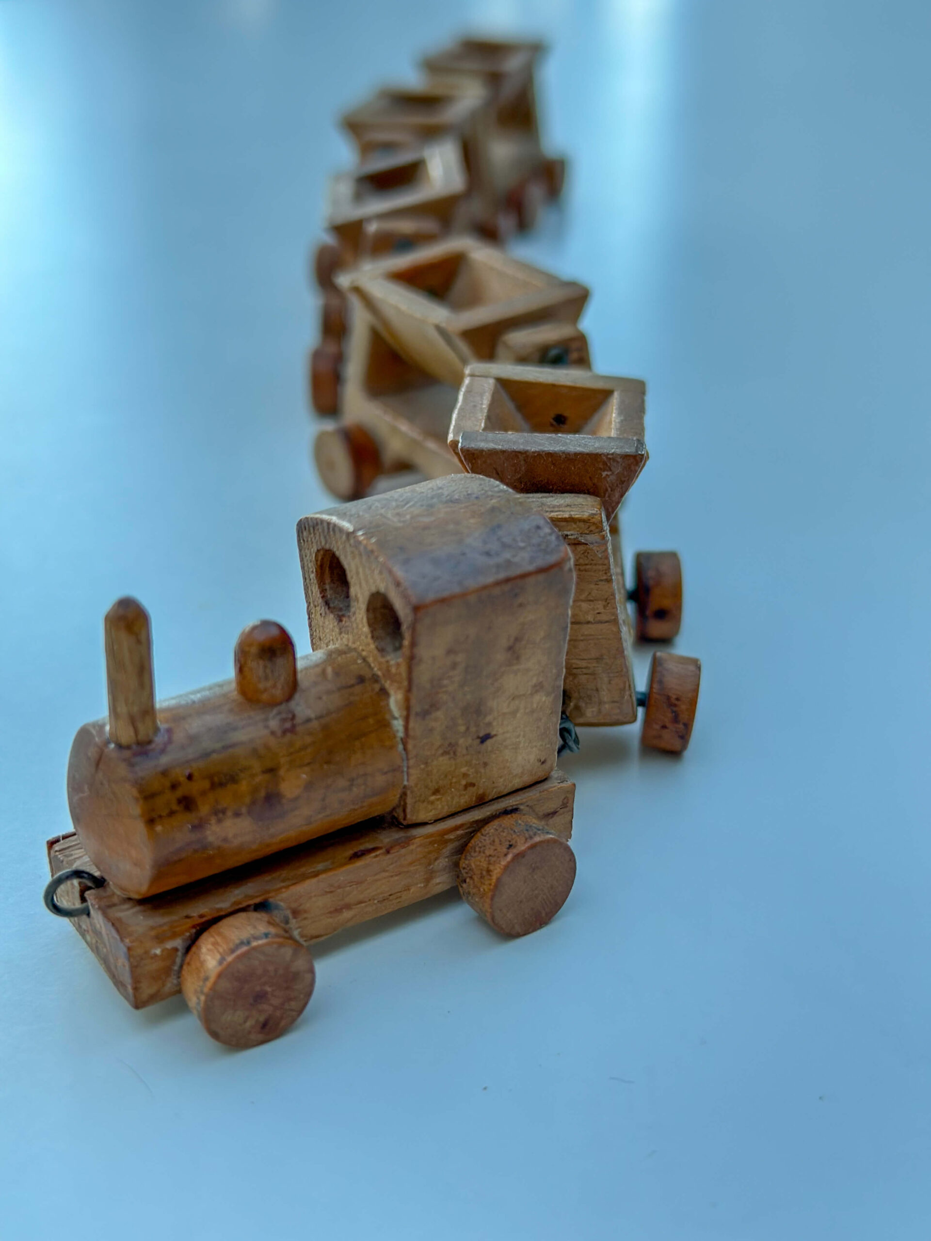 A classic wooden train with a charming engine and attached cars, showcasing craftsmanship