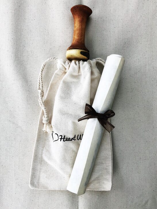 A stylish bag in white and brown with a wooden handle, combining elegance and functionality