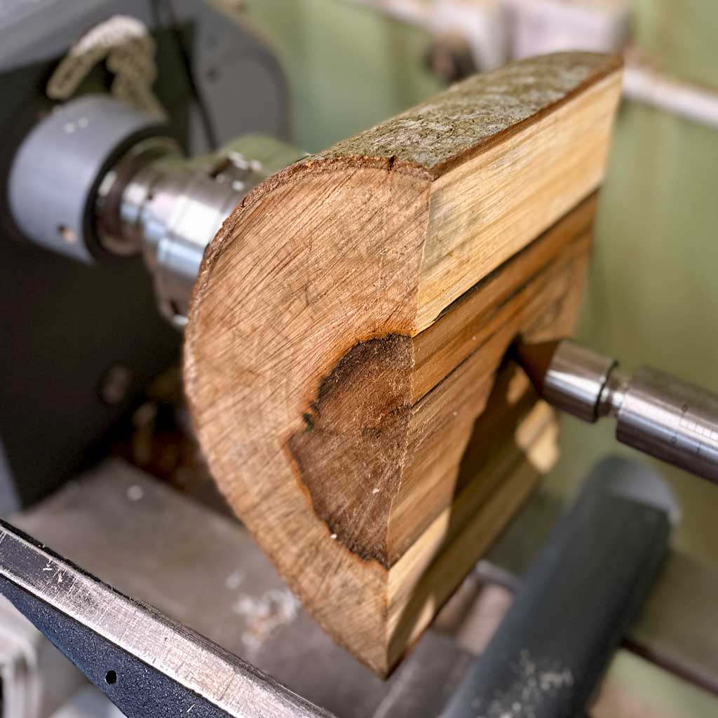 half log mounted on the lathe