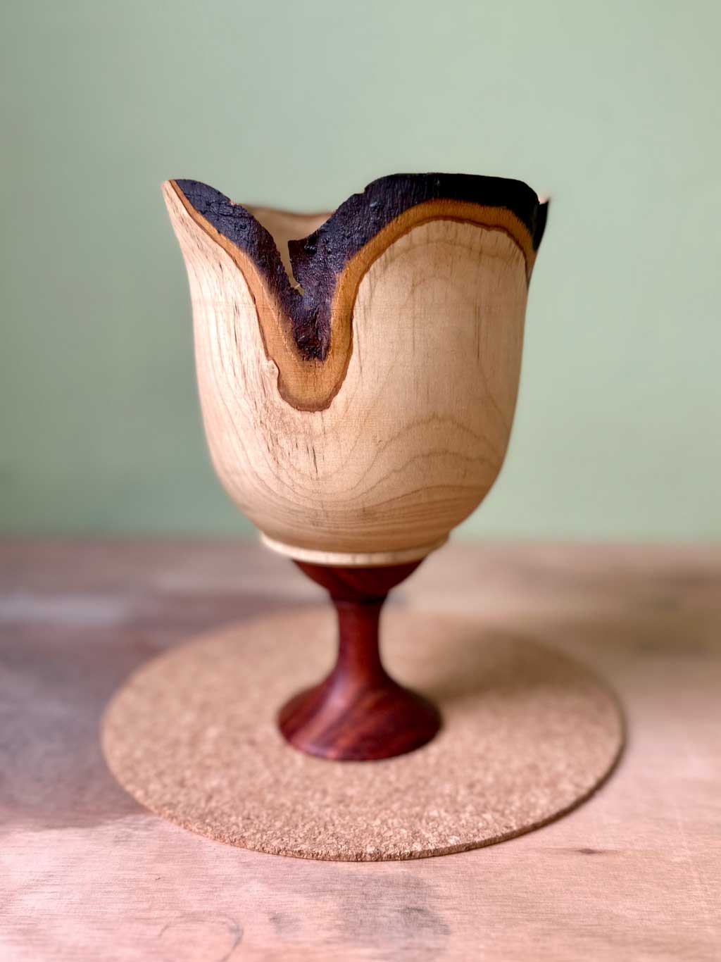 Unfolding end grain vessel made from bay with a rosewood base
