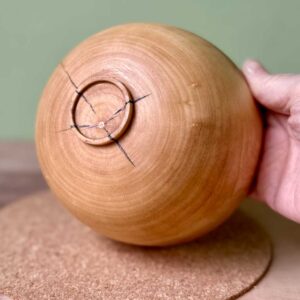 Underside of the Gathered hand turned sycamore vessel showing the turned foot and growth rings.