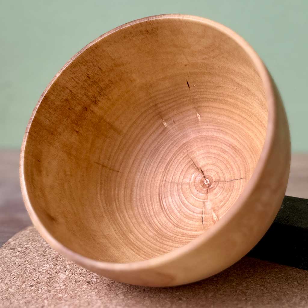 Interior of the Gathered sycamore vessel showing the smooth finish and natural grain.