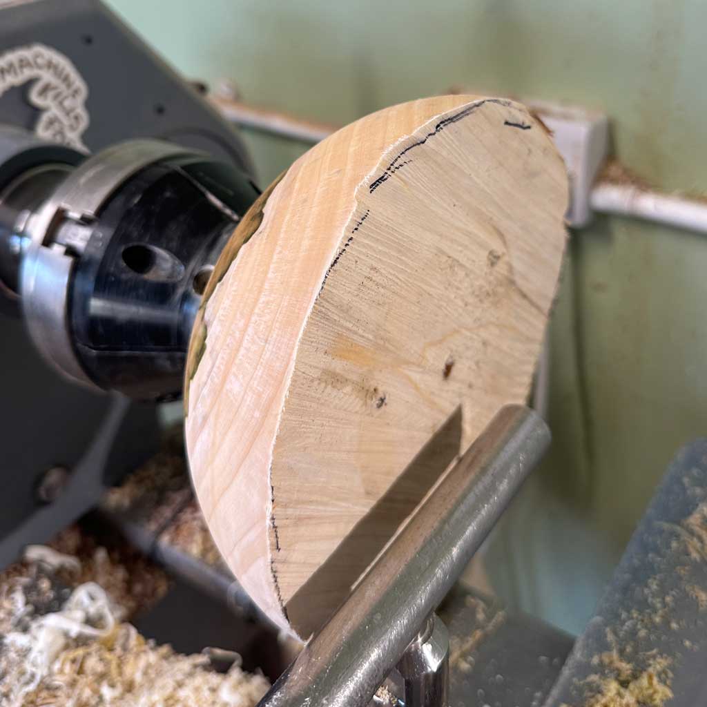 Outside of the Rooted rowan wood vessel being shaped on the lathe.