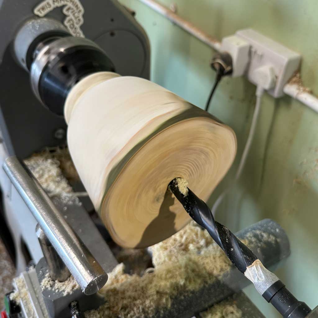 Green bay wood blank mounted on the lathe during the making of Unfolding.