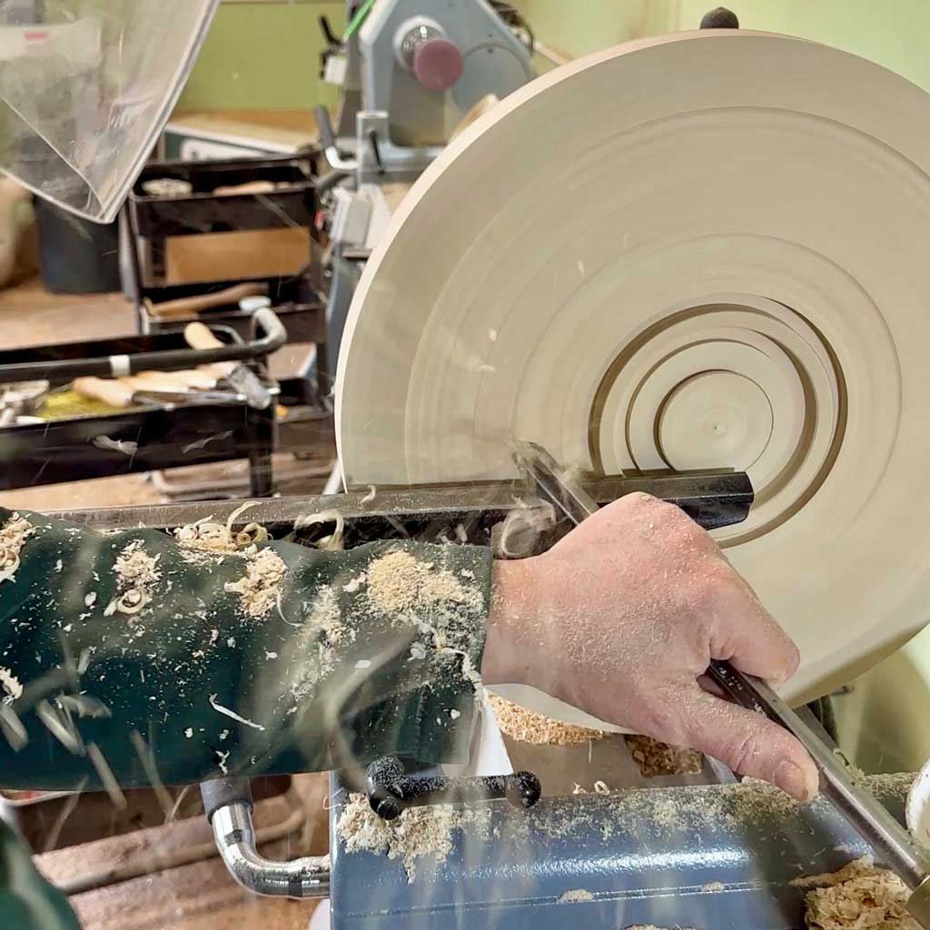 Turning the outside of the ash platter using a bowl gouge.